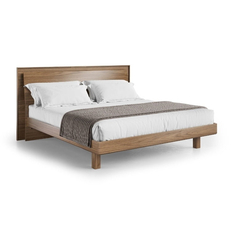 KAVA king bed in walnut with bedding angled view