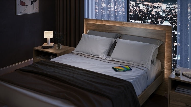 KAVA bed in walnut with headboard lighting in decorated room with nightstands and city view
