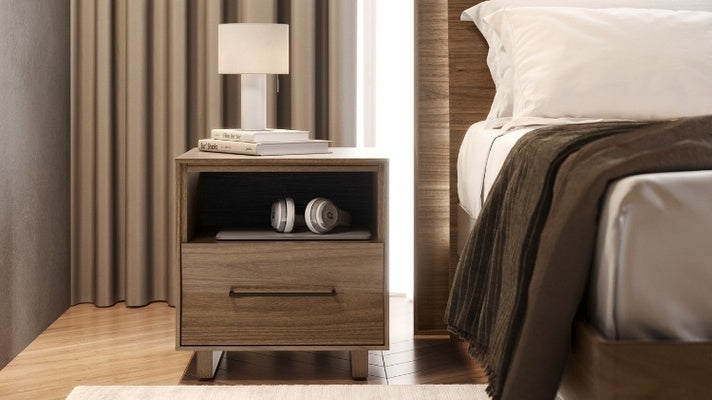 20 KAVA nightstand in walnut in decorated bedroom with books, lamp, and electronics
