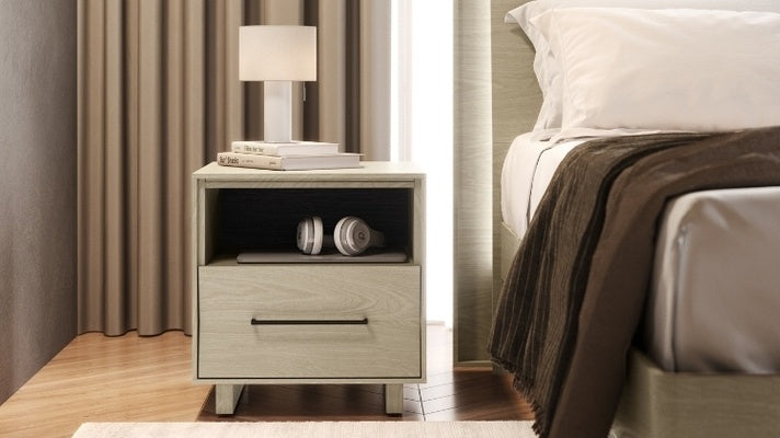 20 KAVA nightstand in washed oak in decorated bedroom with books, lamp, and electronics
