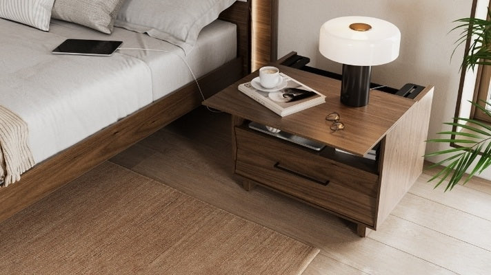 28 KAVA nightstand in walnut with top slid open, with book, glasses, charging tablet, and lamp