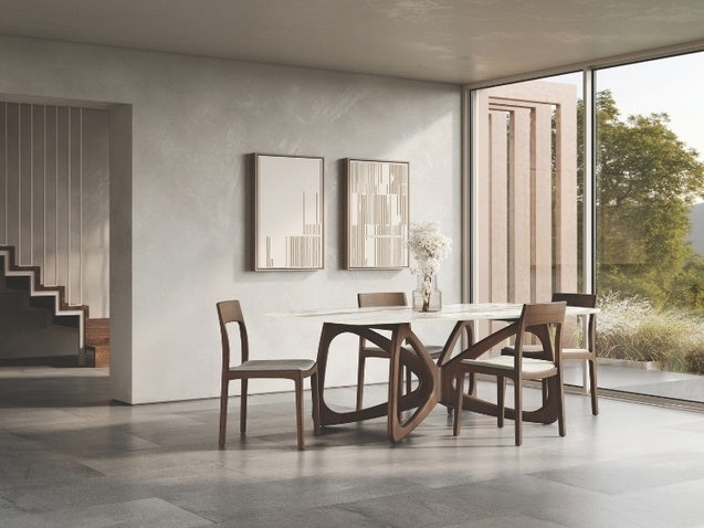 Dining room with a modern table and chairs in a well-lit room with large windows