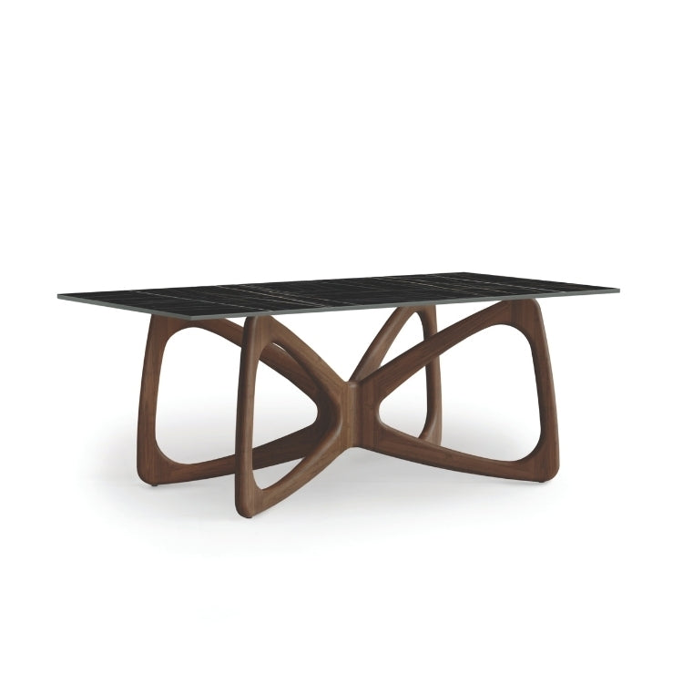 A Butterfly Sintered Stone Top Table with a sculptural wooden base and a black sintered stone tabletop.