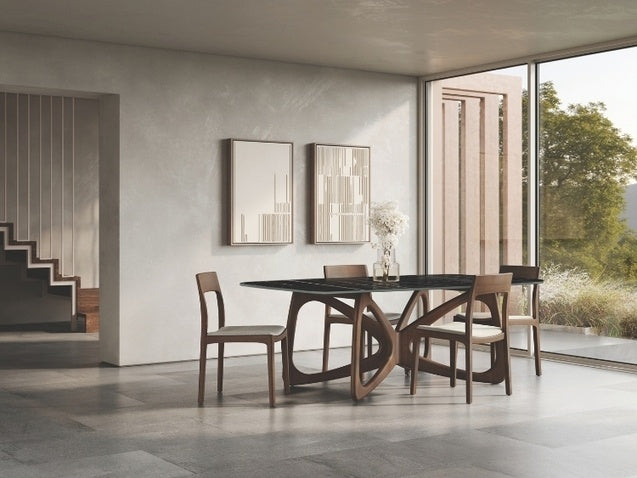 Modern dining room with a black marble table and wooden chairs, large windows, and decorative mirrors.