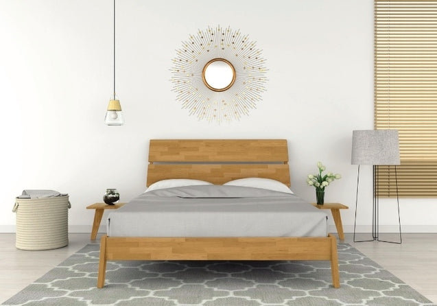 Linn Platform Bed in cherry in decorated bedroom with 2 attached nightstands, lamp, and rug