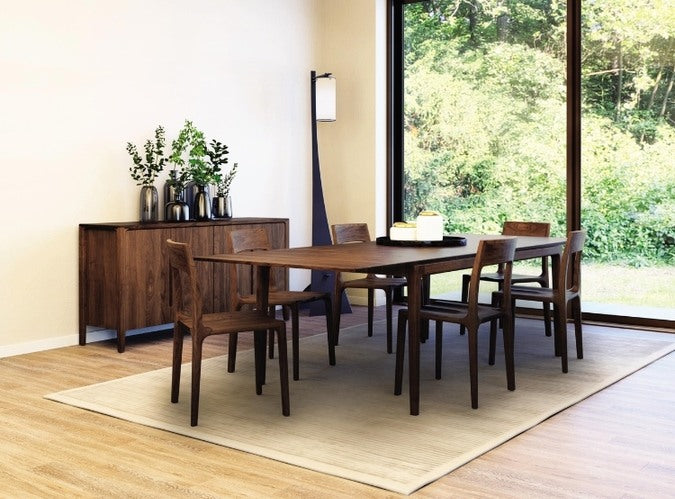 Lisse Extension Table in decorated room with Lisse Chairs, Lisse Buffet, lamp, and rug.