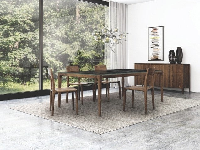 Lisse Stone Top Table in Sahara Noir in decorated dining room with chairs and credenza