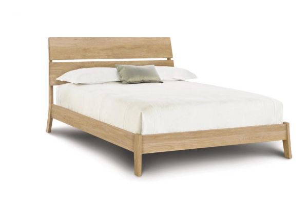 Linn Oak Platform Bed with slatted headboard, and angled legs.