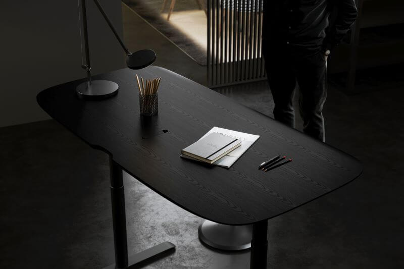 Soma 6351 Lift Desk in Ebonized Ash with pencils, paper, and lamp on top
