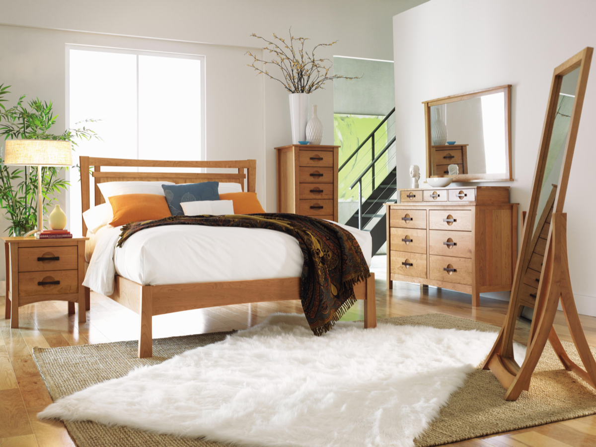 Monterey 6 Drawer Dresser and Accessory Case in cherry, in decorated room with bed, nightstand, and layered rugs