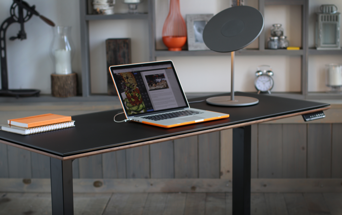 Staged closeup of the Sequel 20 6151 Lift Desk by BDI Furniture in Charcoal Stained Ash