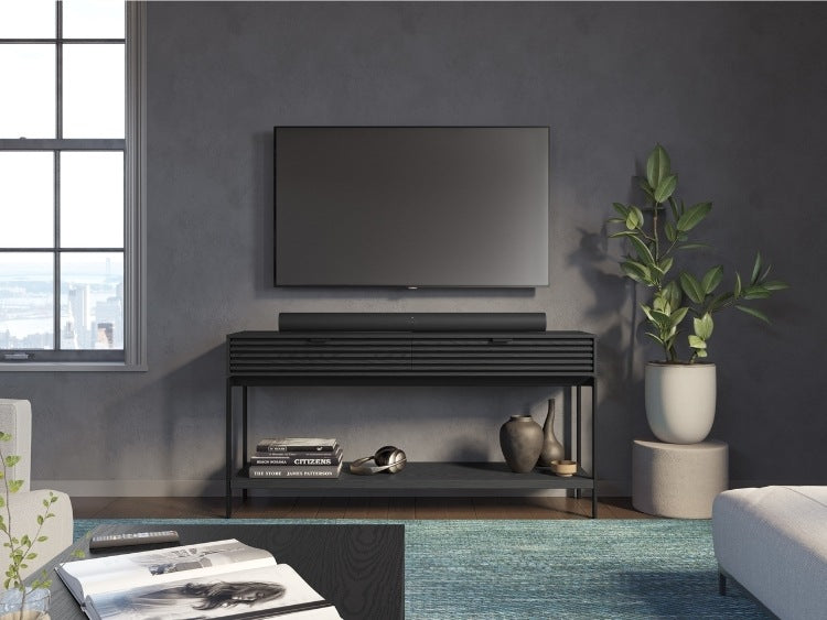 Cora 1173 Console in Charcoal Stained Ash in entertainment room with television, seating, and rug