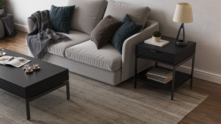 Cora 1176 End Table in Charcoal Stained Ash with books, decor, sofa, and rug