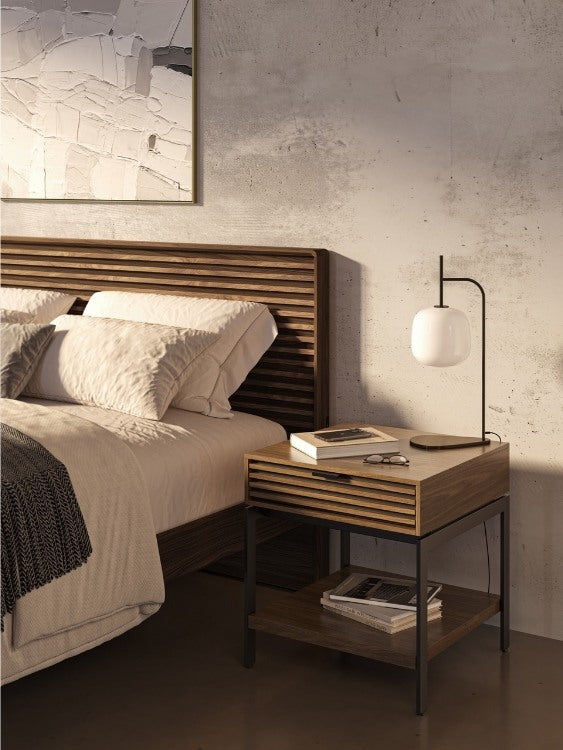 Cora 1176 End Table in Walnut in bedroom with bed, books, and lamp