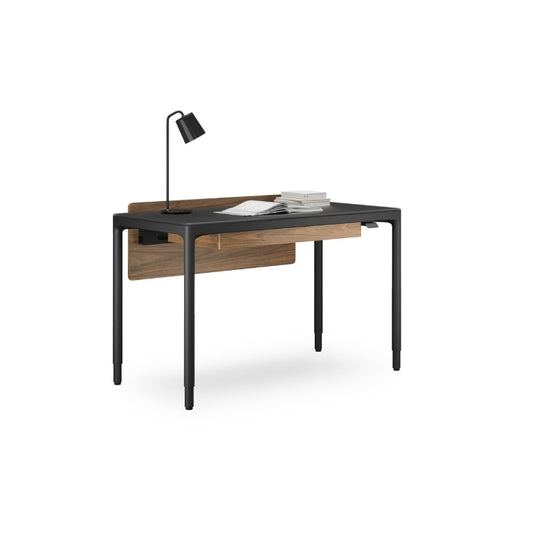 Luma Small Sit/Stand Desk in Black with Walnut modesty panel, lamp, and books