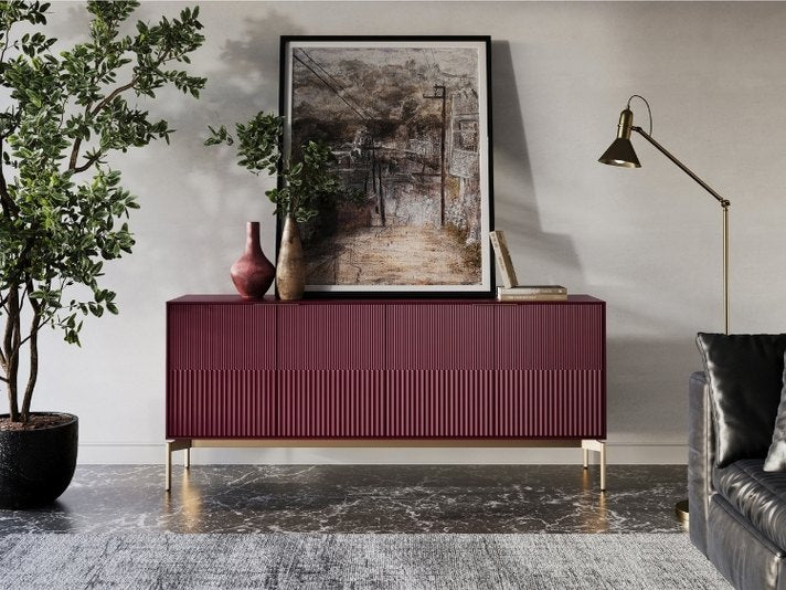 Modern living room with a burgundy sideboard, gray sofa, and decorative items.