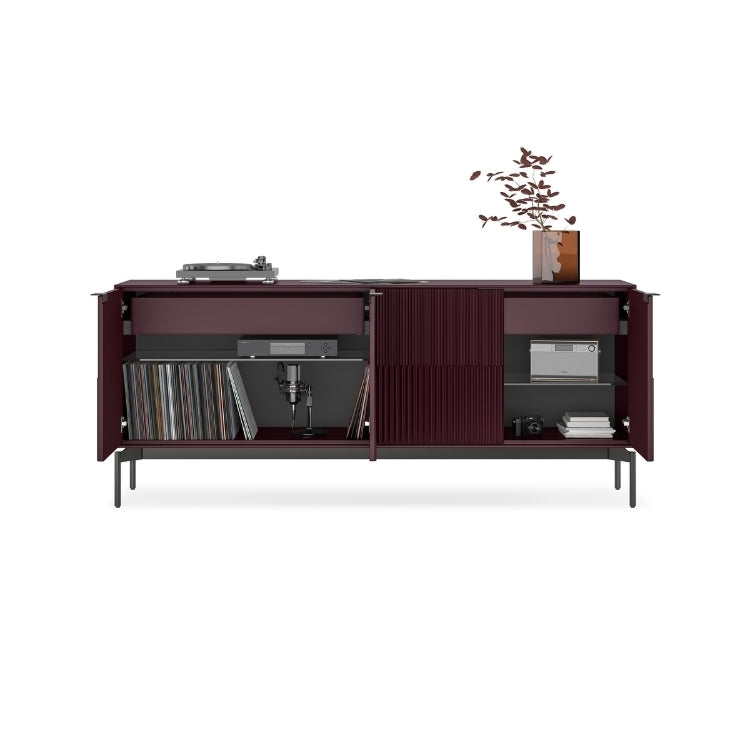 Modern dark wood entertainment console with shelves and decorative items on a white background