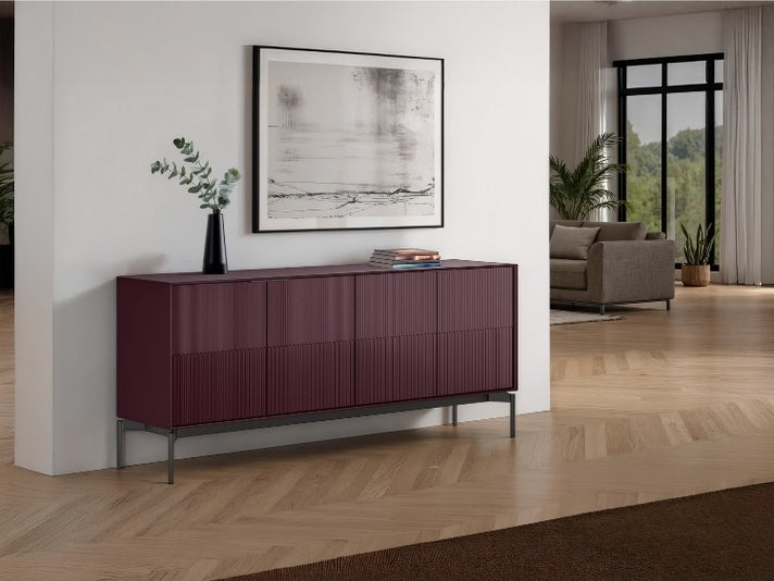 Modern living room with a purple sideboard, framed artwork, and a sofa.