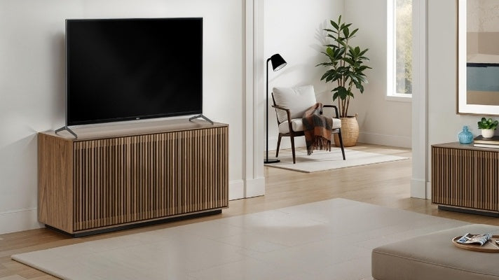 Wooden TV stand with a television in a modern living room.