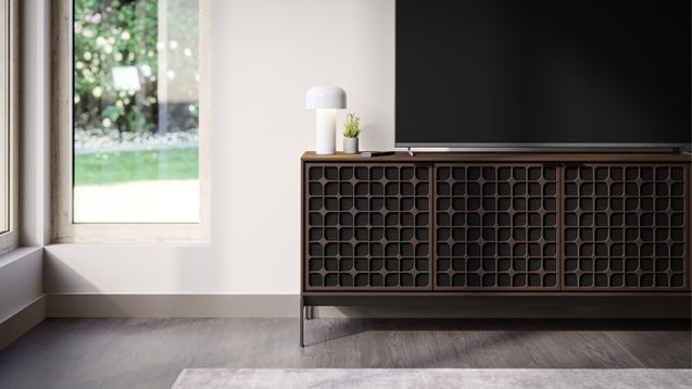 Elements 8709 Media and Storage Console in Constellation Toasted Oak in entertainment room with television