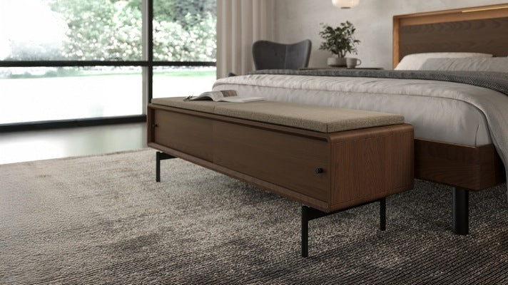 LINQ Bench in walnut with pecan cover in decorated room at the food of a bed, with chair and rug