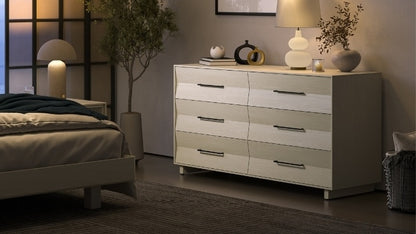 KAVA 6 drawer dresser in washed oak in decorated room with lamp, plant, vases, and books, near bed and nightstand