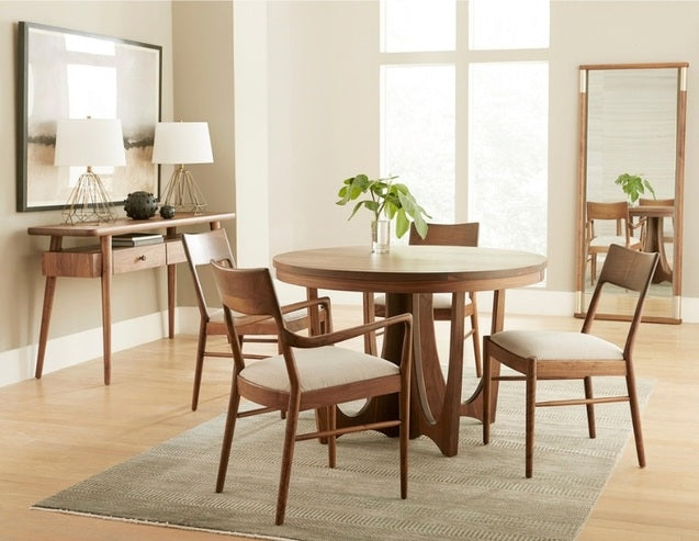 Walnut Grove Round Dining Table in decorated dining room with chairs, console, and rug