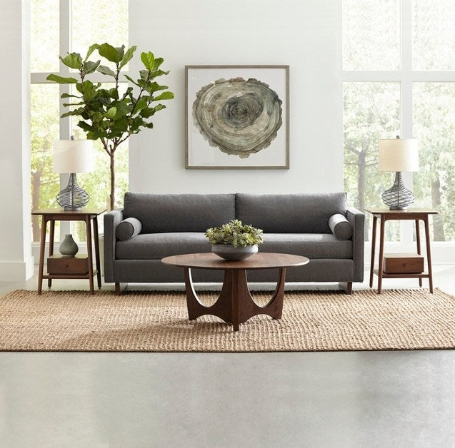 Walnut Grove Round Cocktail Table in decorated living room with end tables, sofa, and rug