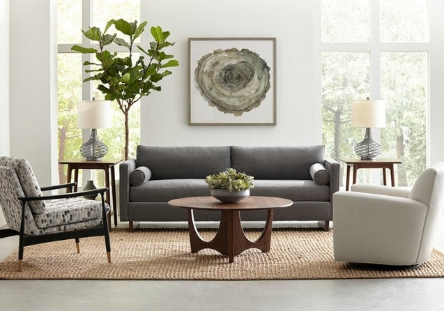 Walnut Grove Round Cocktail Table in decorated living room with end tables, seating, and rug