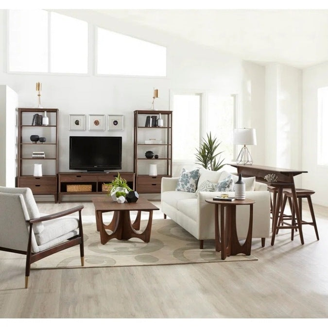 Walnut Grove Entertainment Console in decorated living room with shelving, gathering island, cocktail table, and seating