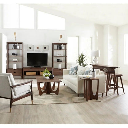 Walnut Grove Entertainment Console in decorated living room with shelving, gathering island, cocktail table, and seating