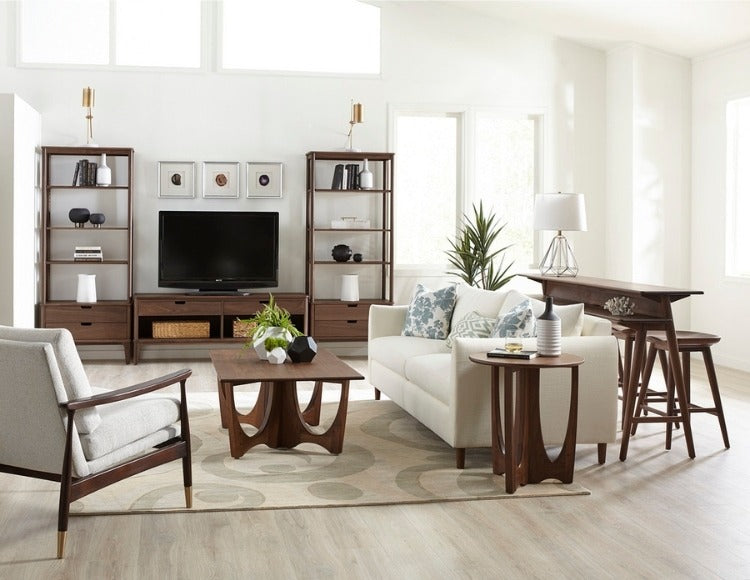 Walnut Grove Bookcases in decorated living room with gathering island, cocktail table, and seating