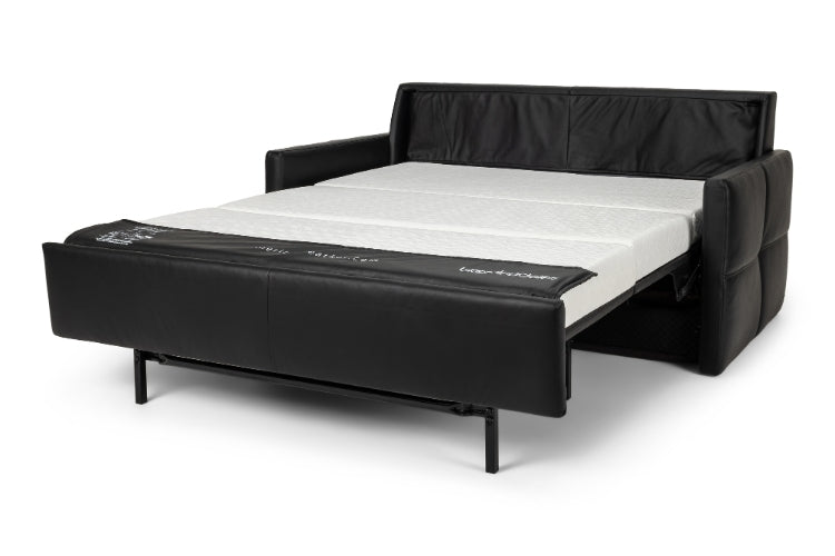 Black leather sofa bed with white mattress on a white background