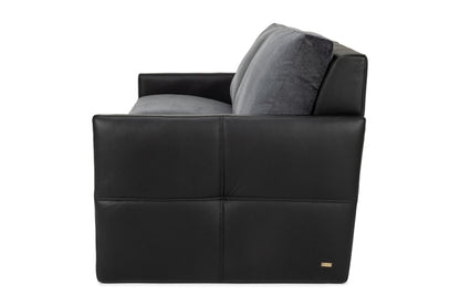 Side view of modern black leather armchair with gray cushions