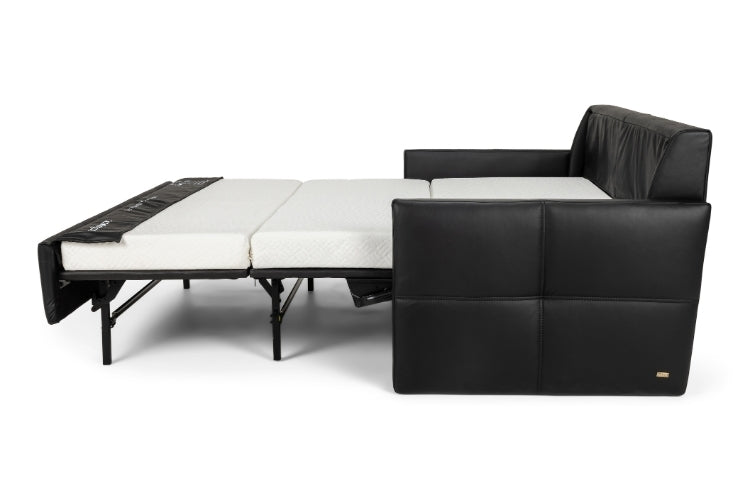 Black leather sectional sofa with white mattress on a white background