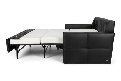 Black leather sectional sofa with white mattress on a white background