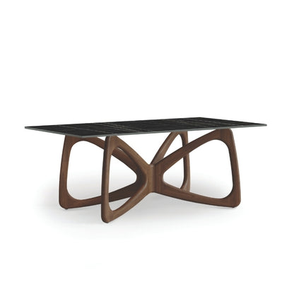 A Butterfly Sintered Stone Top Table with a sculptural wooden base and a black sintered stone tabletop.