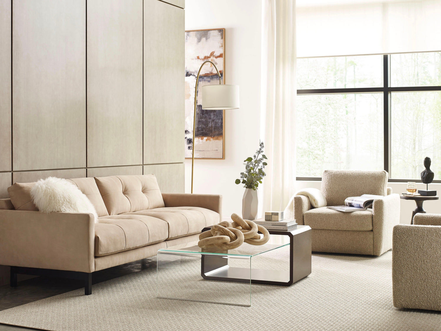Beige Carmet High Leg Sofa with contemporary armchair and glass coffee table in modern living room