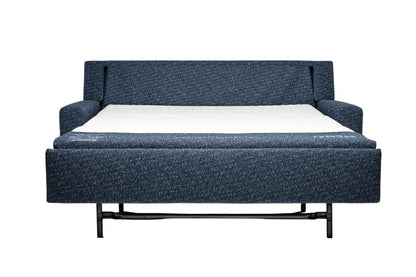 Navy blue sectional sofa bed pulled out to full size showing white mattress. 