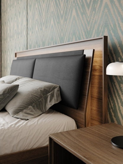 King Size Contour Headboard Cushion in Pepper leather lifestyle with bedding, headboard lighting, and nightstand