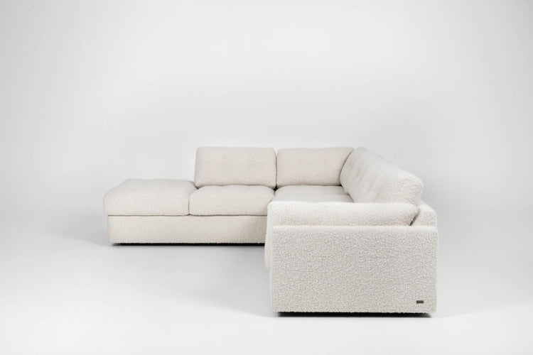 Side view of Beige sectional sofa on a white background
