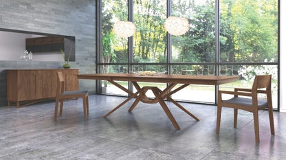 Exeter Extension Table walnut extended in a decorated room with chairs and a buffet.