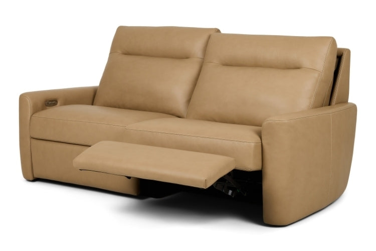 Tan leather sofa with reclining feature on a white background