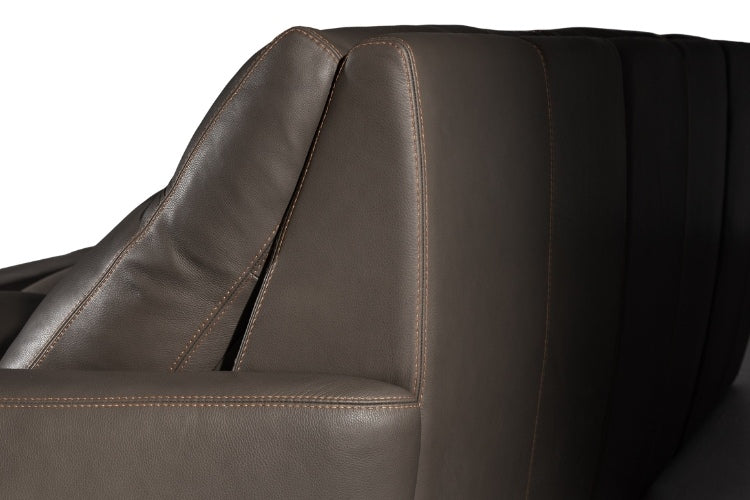 Close-up of a brown leather sofa with visible stitching.
