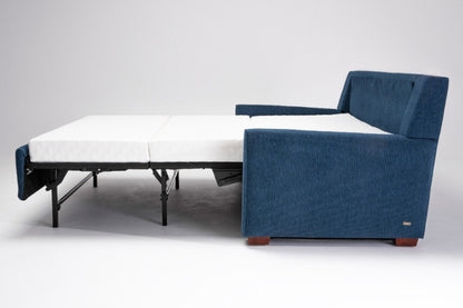 Side view of Blue sofa bed with white mattress 