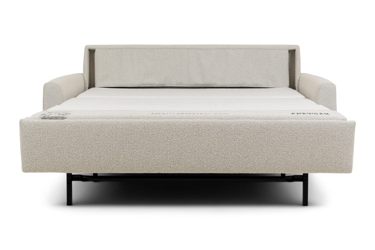 Beige sofa bed pulled out into bed positon