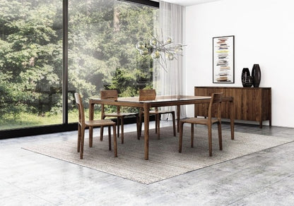 Lisse Glass Top Table in decorated room with Lisse Chairs, Lisse Buffet, and rug.
