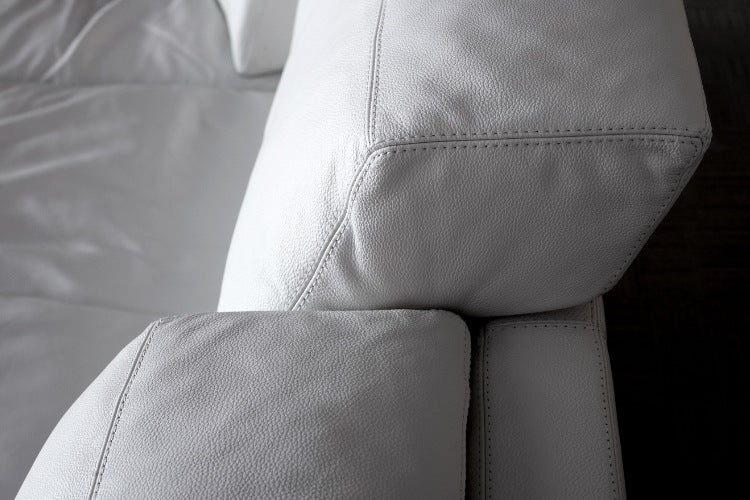 Close-up of gray leather sofa with stitching details