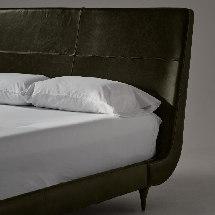 Closer view of fabric of Menlo Park Bed Reimagined Green Leather Upholstered with white bedding and pillows 