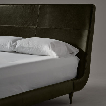 Closer view of fabric of Menlo Park Bed Reimagined Green Leather Upholstered with white bedding and pillows 